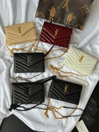 Assorted small YSL shoulder bags, beige, burgundy, black, cream with chain straps