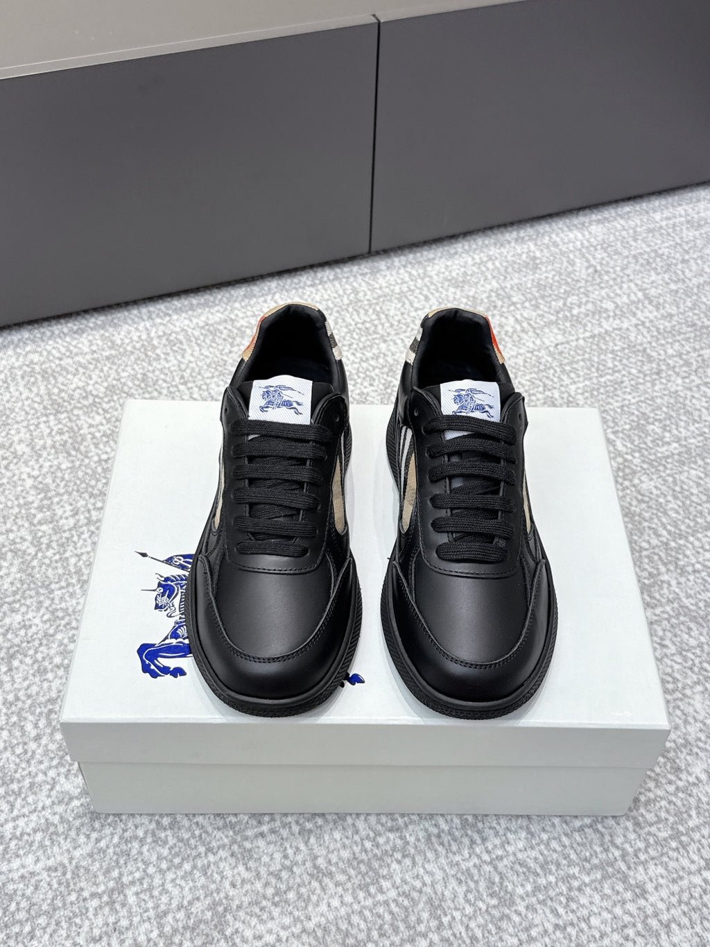 Burberry black leather sneakers with lace-up front and check-panel side