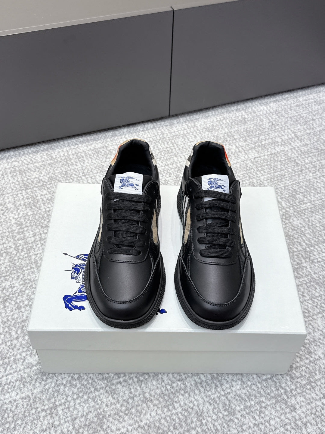 Burberry black leather sneakers with lace-up front and check-panel side