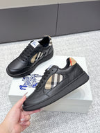Burberry black leather sneaker with check-panel side stripe and textured rubber sole