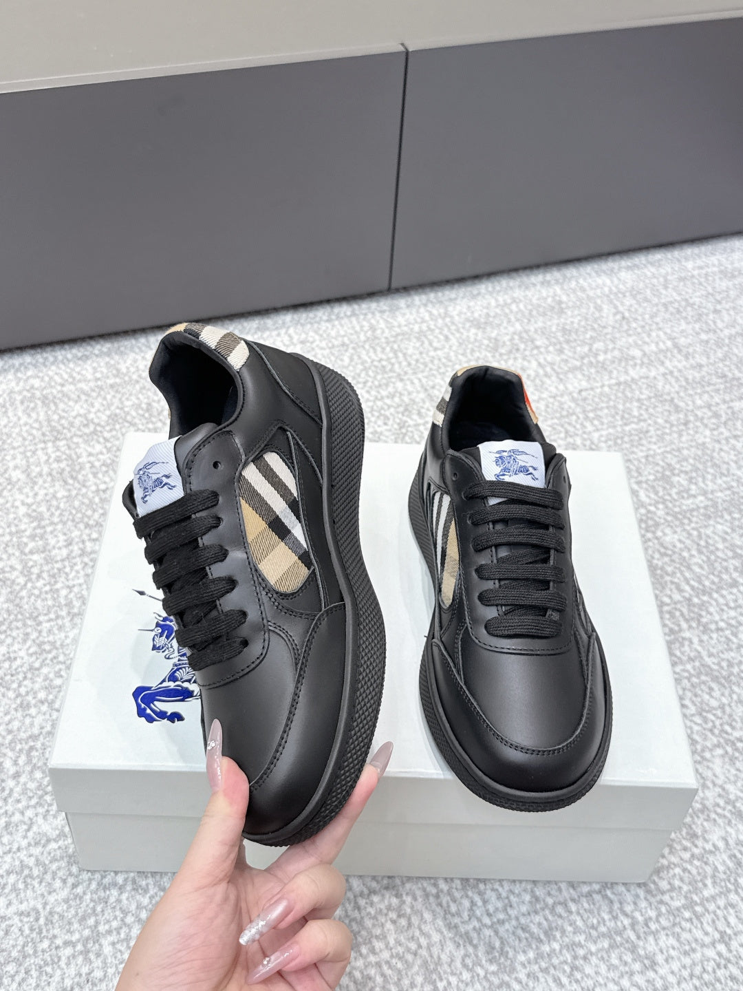 Burberry black leather sneakers with check-panel uppers and lace-up closure