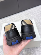 Burberry sneakers with black heel, check-panel inserts, and blue traction outsole detail