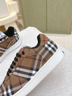 Burberry sneaker close-up, brown plaid fabric with black laces and round eyelets