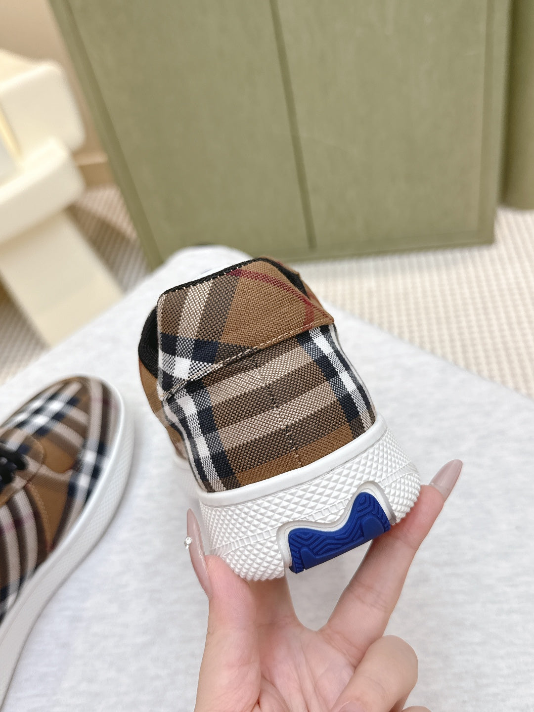 Burberry sneaker heel detail, brown plaid upper with blue accent and white rubber sole