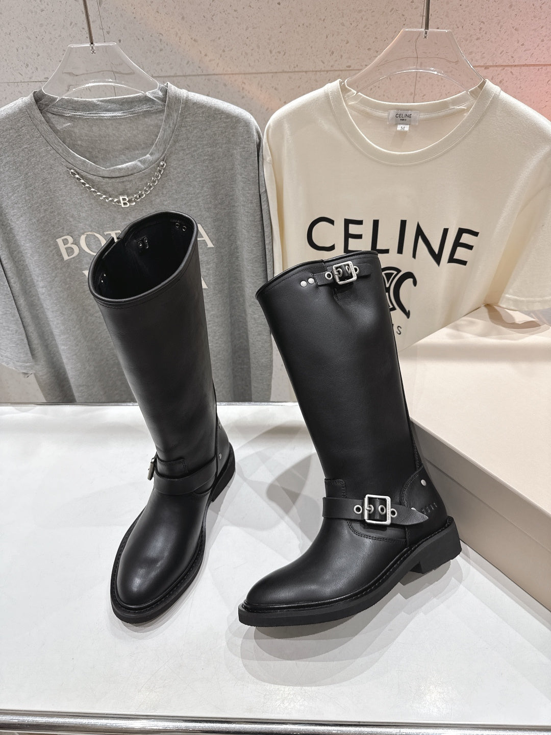 Black tall boots with front buckle straps and low block heel
