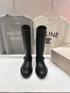 Pair of black tall buckle boots with rounded toe and chunky sole