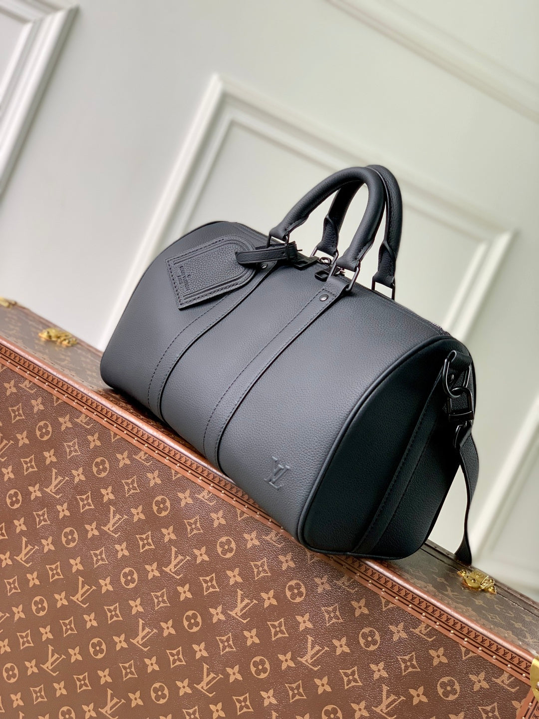 Men's Louis Vuitton duffel bag, dark gray leather with front pocket and side straps.
