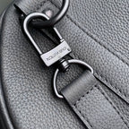 Louis Vuitton strap clasp and ring hardware on dark gray pebble-grain leather.
