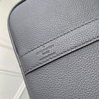Louis Vuitton logo patch on dark gray pebble-grain leather flap with stitched edge.