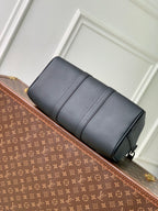 Men's Louis Vuitton duffel bag, dark gray leather side view with zippered top.