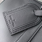 Louis Vuitton leather detail with embossed stitching and zipper track on dark gray leather.