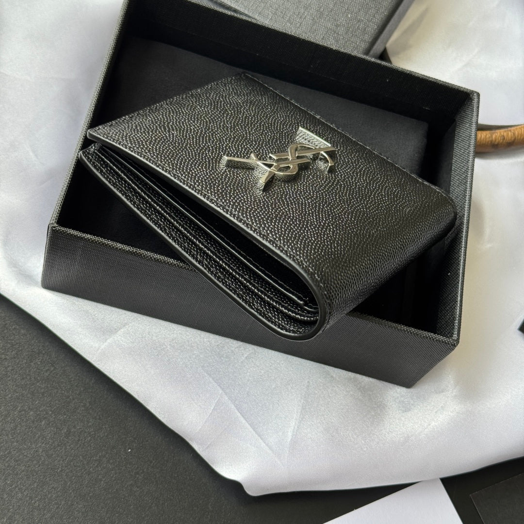 Black textured small wallet bag opened to show long zipper compartment