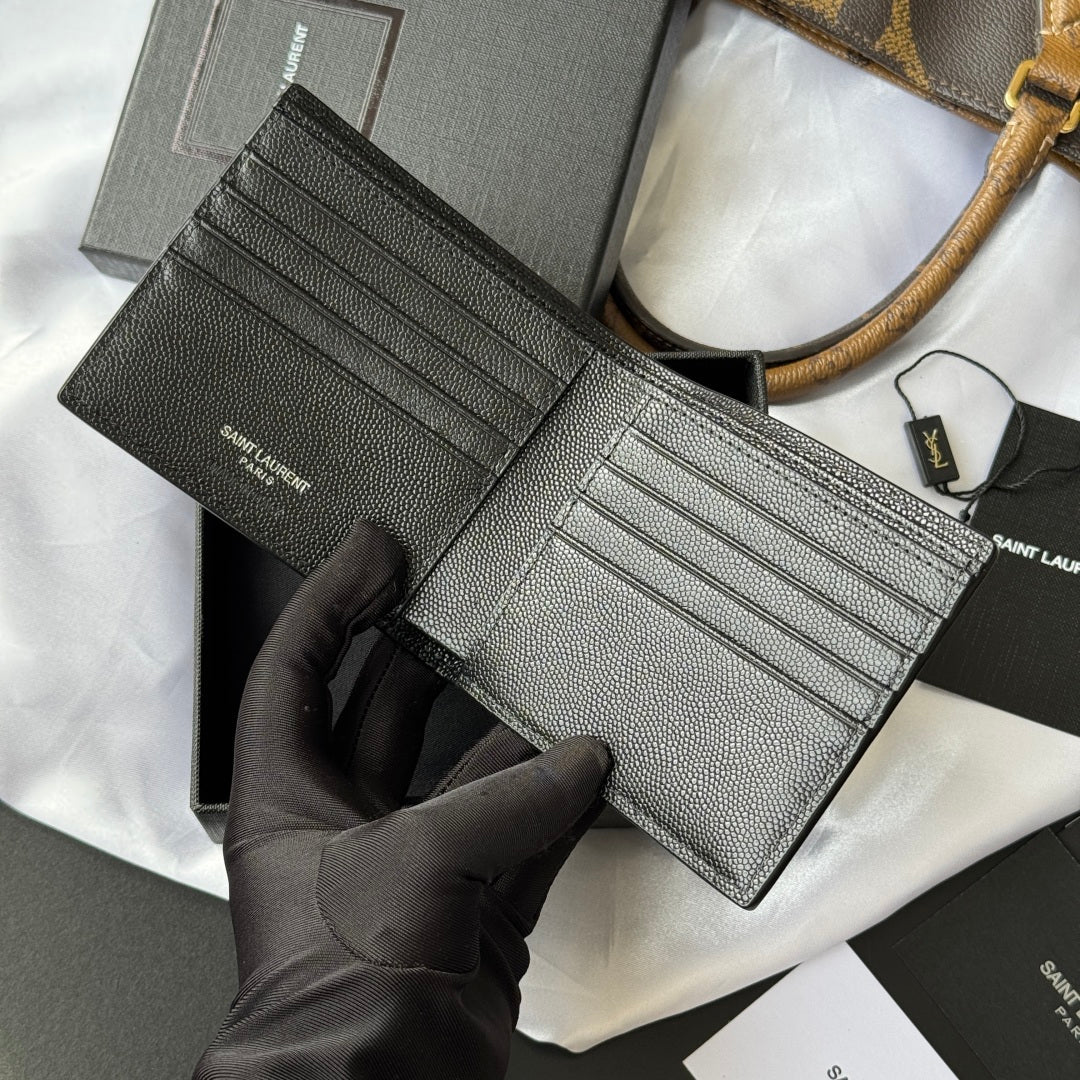 Small textured leather card holder wallet with interior card slots, shown open