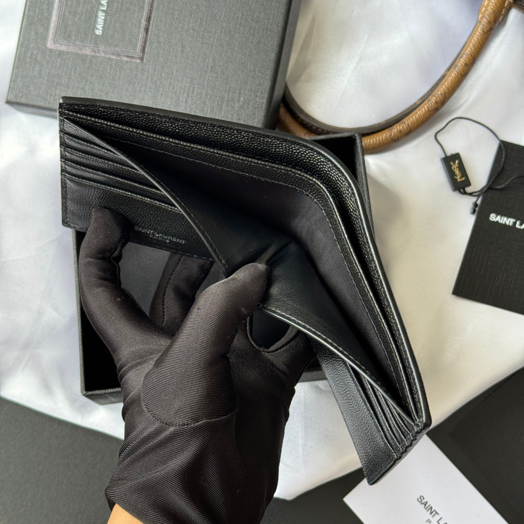 Small textured leather card holder wallet edge close-up held in black glove
