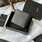 Black textured small wallet bag with front flap and minimal logo detail