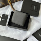 Small textured leather card holder wallet with YSL logo, laid over gift packaging