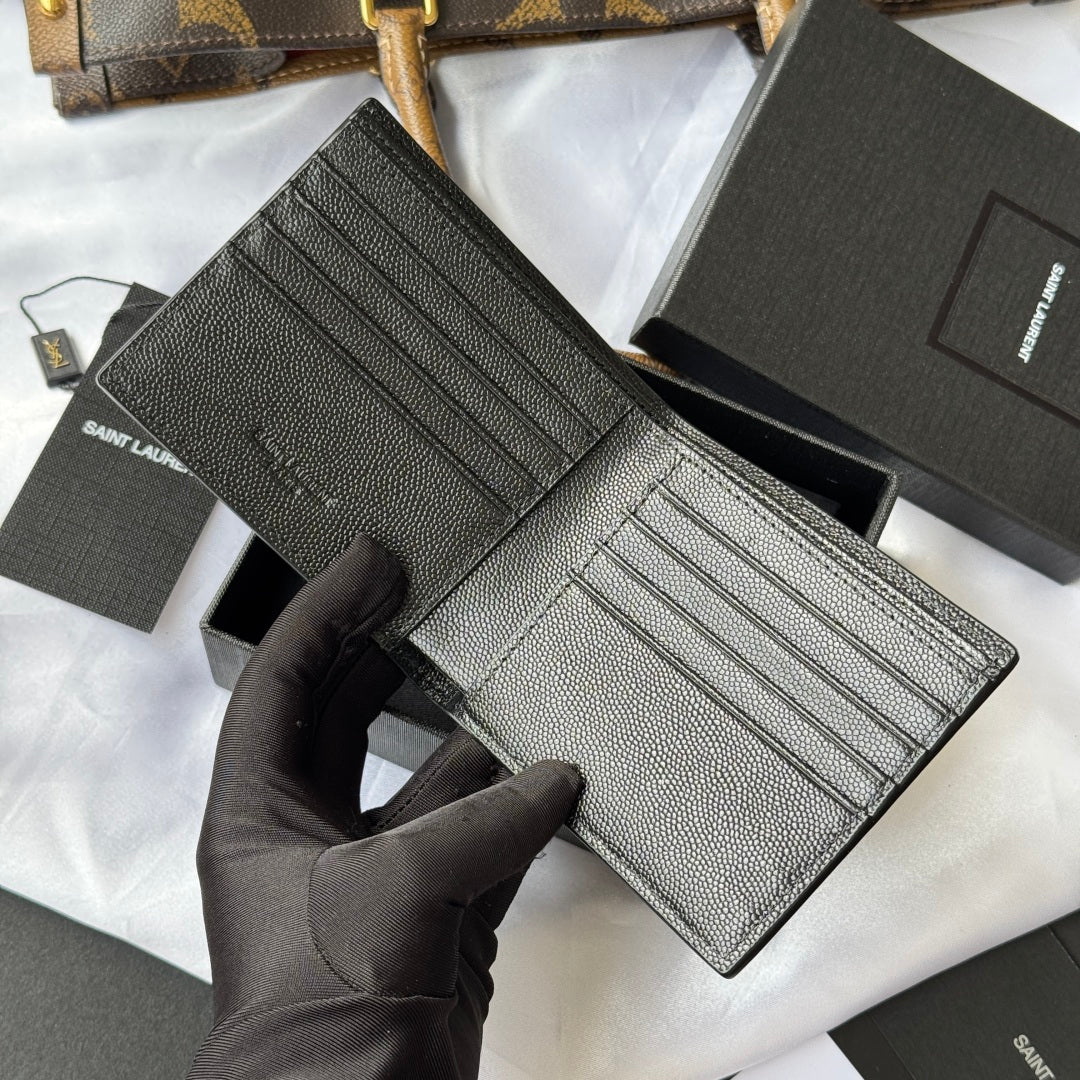 Small bag open with multiple card slots in textured leather interior