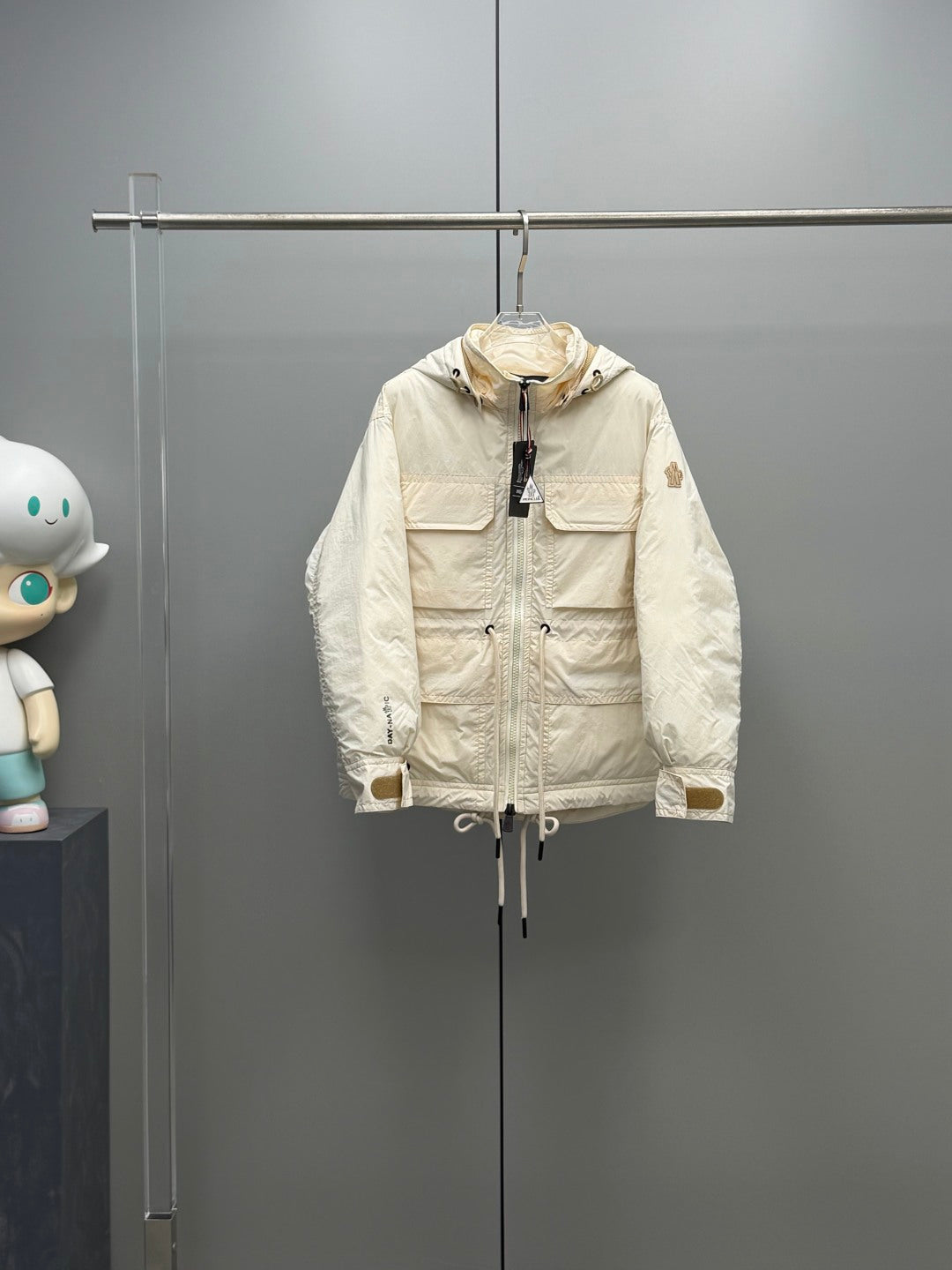 Light beige Moncler long hooded jacket with front zipper and snap pockets