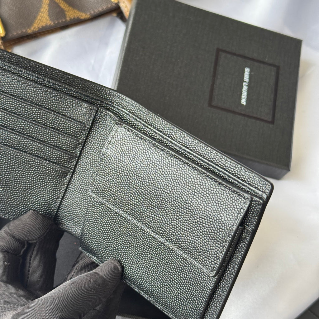 Small leather bag interior view with card slots and stitched fold edge