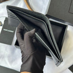 Small leather bag open view with interior panels and card slots visible