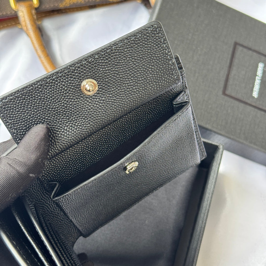 Textured small bag with flap and gold snap hardware, partially open in dark gray