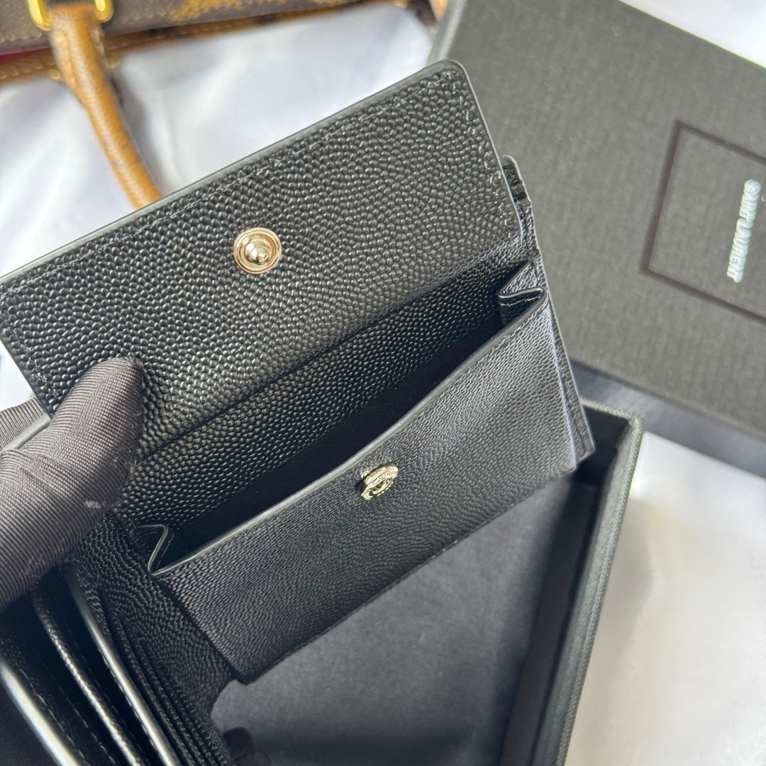 Textured small bag with flap and gold snap hardware, partially open in dark gray