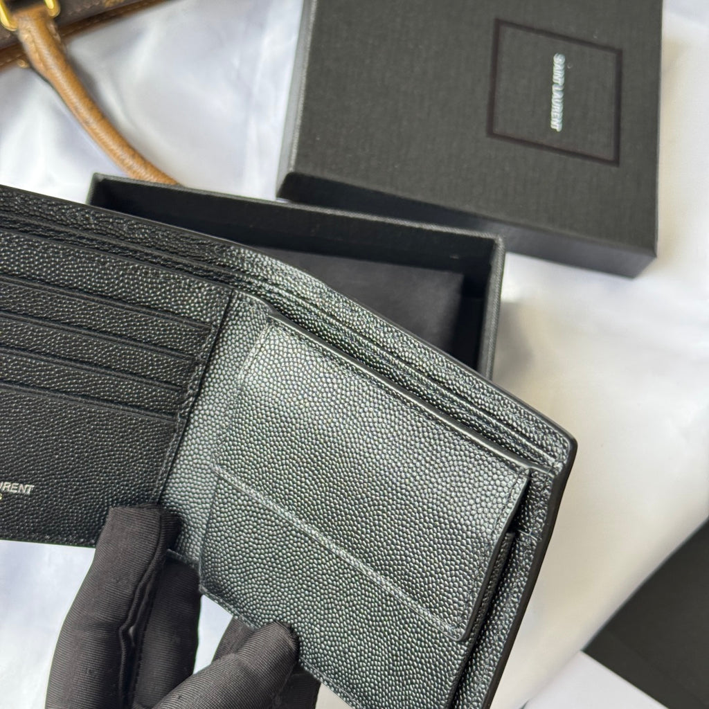Black textured leather card holder close-up of folded compartments