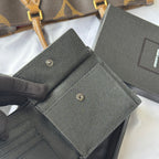 Textured dark small flap bag with two snap buttons and inner pocket