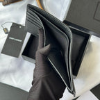 Black textured leather small bag with zip opening, interior compartments visible