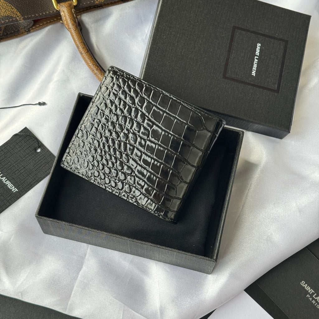 Small crocodile-embossed leather card case with gold logo, side angle in box