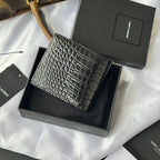 Small crocodile-embossed leather card case with gold logo, side angle in box