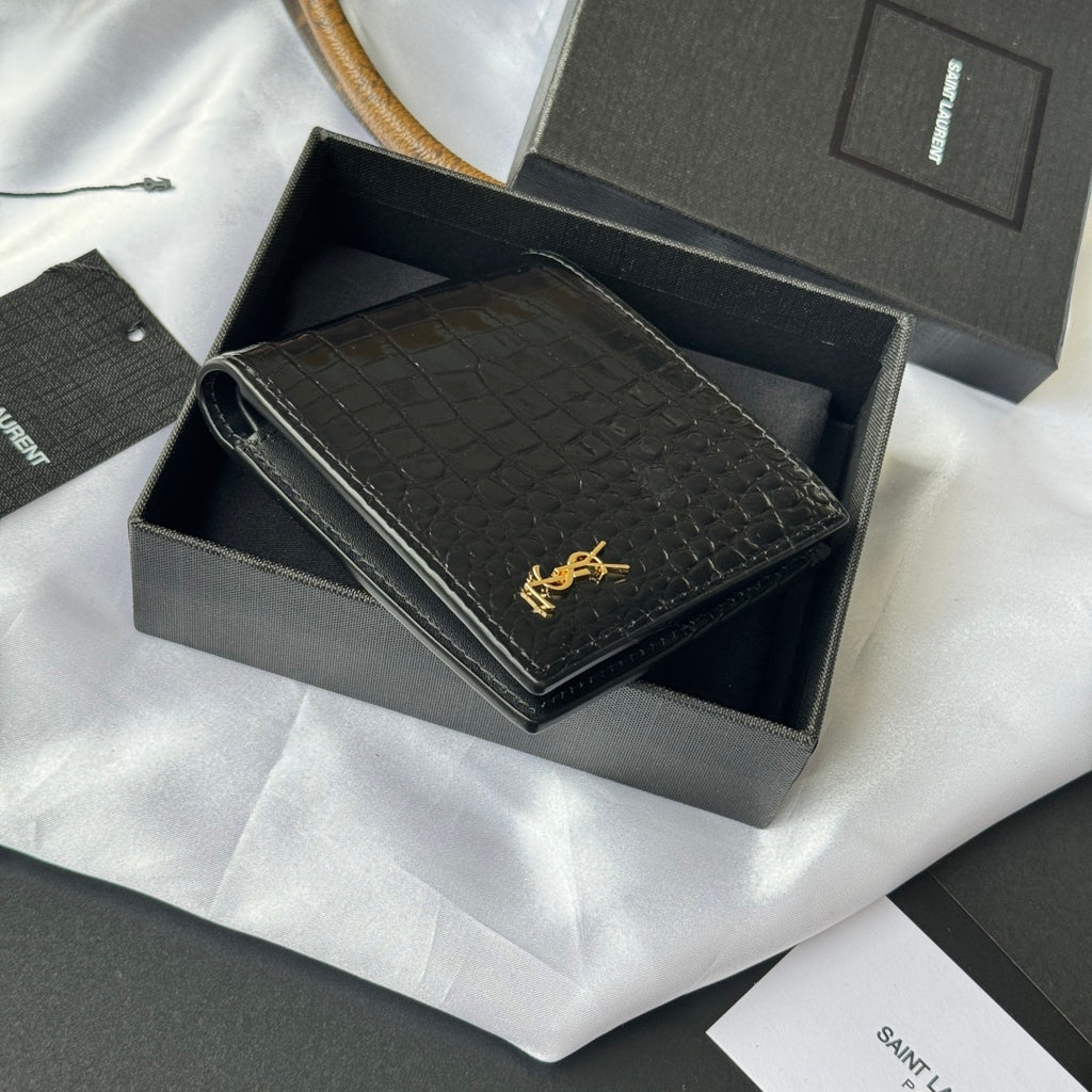 Small leather card case with crocodile emboss and gold logo, partially opened