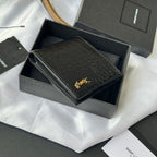 Small leather card case with crocodile emboss and gold logo, partially opened