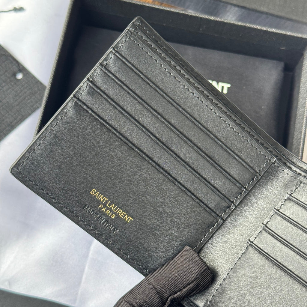 Small leather card case with card slots and stitched edges, logo on inner panel