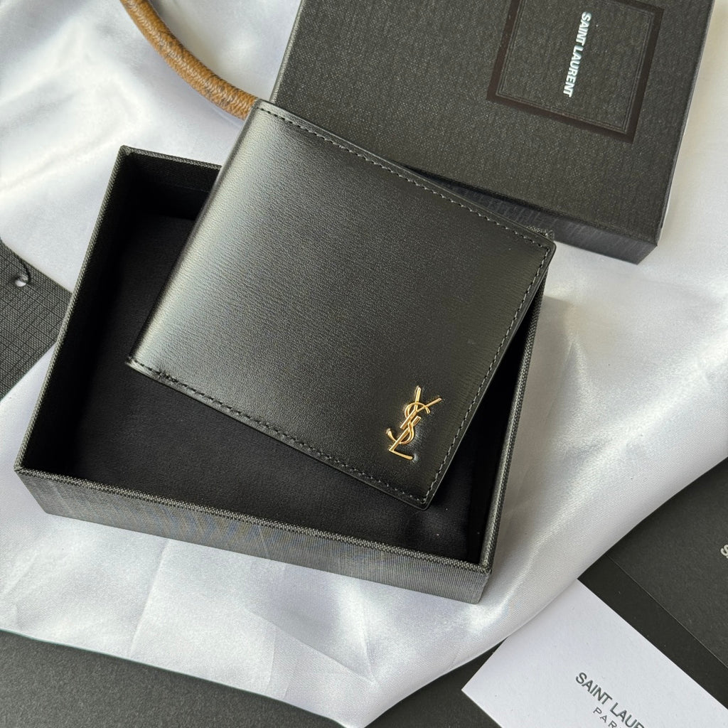 Small bag wallet with stitched edges, gray exterior, gold YSL-style logo on flap