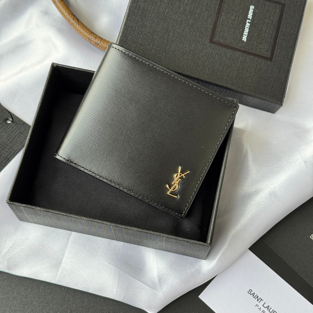 Small bag wallet with stitched edges, gray exterior, gold YSL-style logo on flap