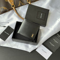 Small bag with foldover design, dark gray leather-look finish, gold logo accent