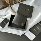 Small bag with foldover design, dark gray leather-look finish, gold logo accent