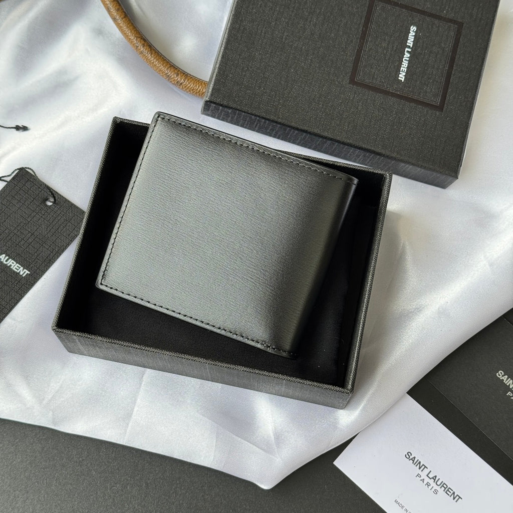 Small bag wallet with light gray exterior, stitched border, and gold YSL-style logo