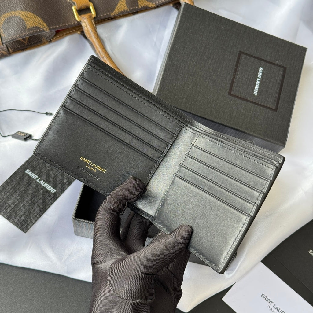 Small bag wallet opened, dark exterior with interior card compartments and gold logo