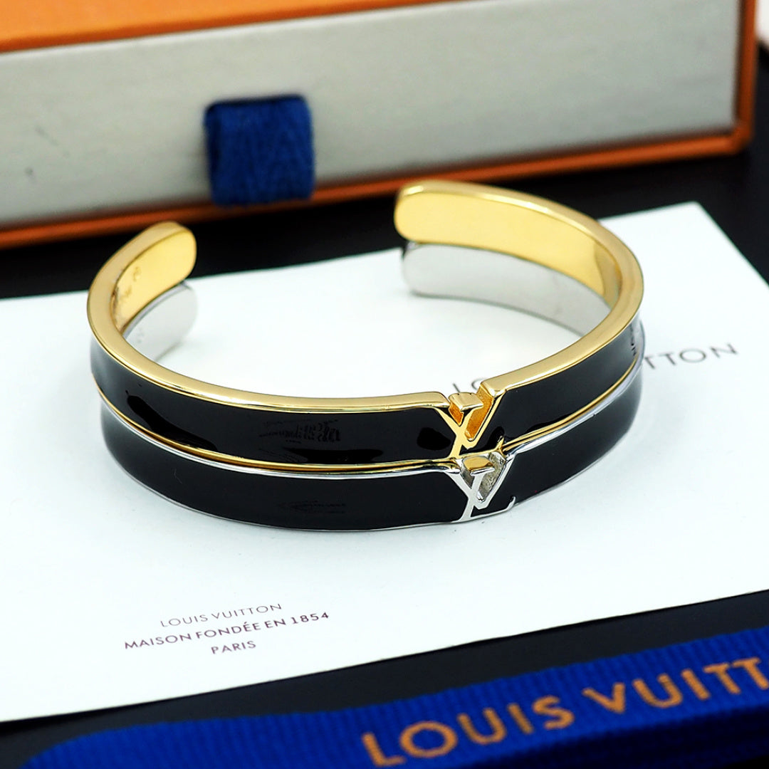 Louis Vuitton cuff bracelet in black with gold LV emblem and hinged clasp