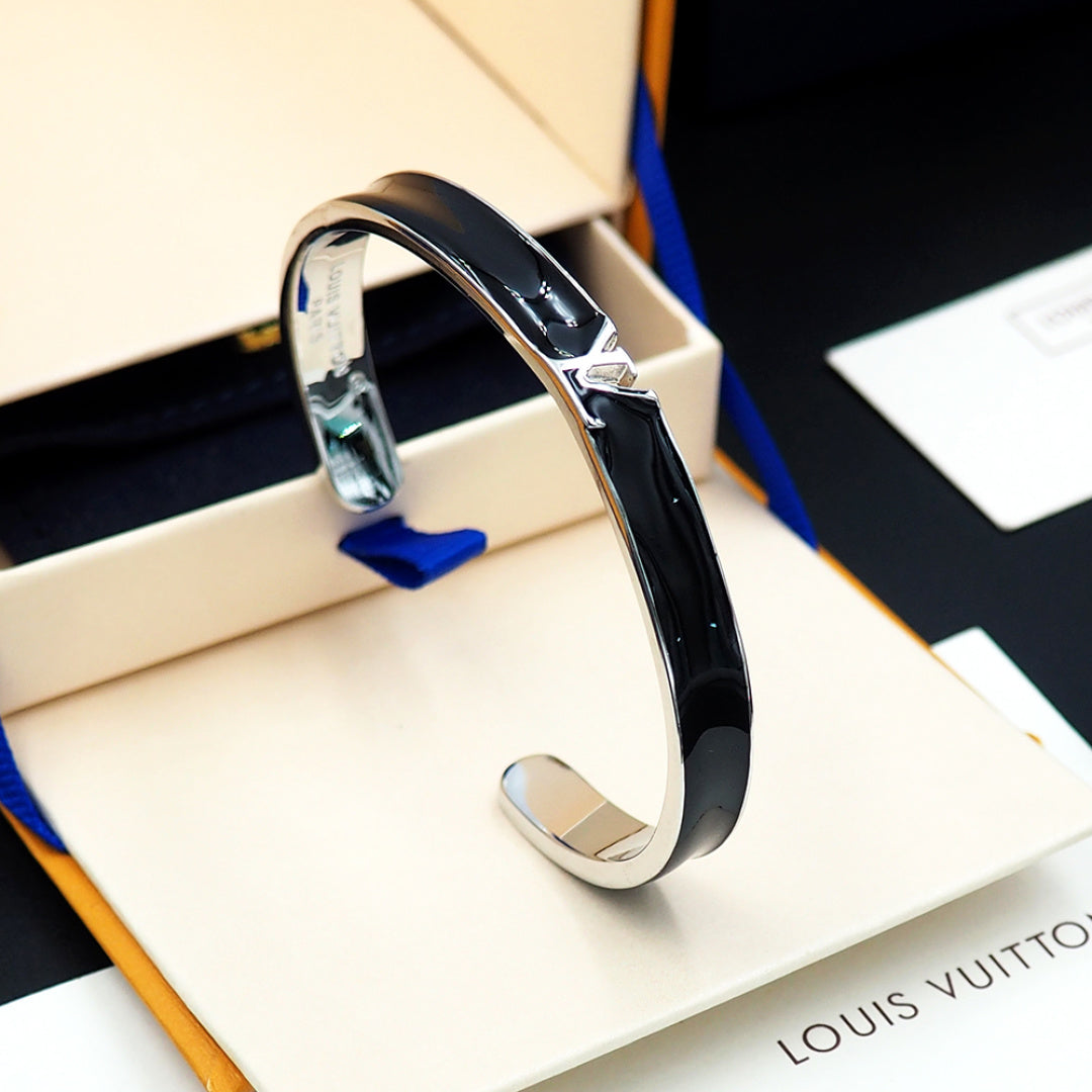 Louis Vuitton bracelet with black enamel band and silver-tone clasp in display box
