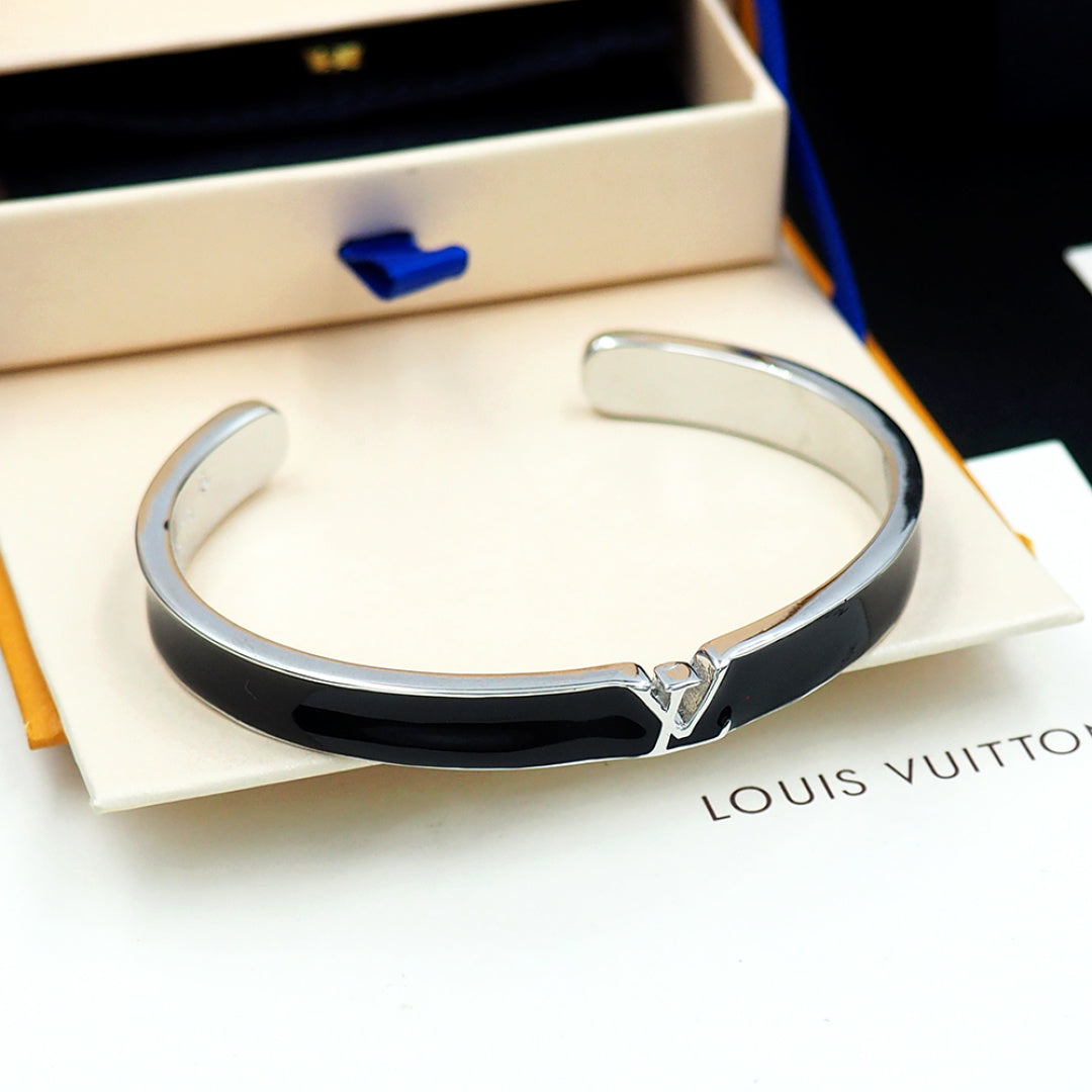 Louis Vuitton cuff bracelet with black enamel band and silver-tone V clasp