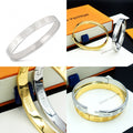 Louis Vuitton engraved silver cuff bracelet with repeating monogram-style pattern
