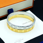 Louis Vuitton two-tone cuff bracelet with gold and silver engraved pattern