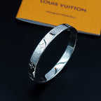 Louis Vuitton engraved silver cuff bracelet with textured motif design
