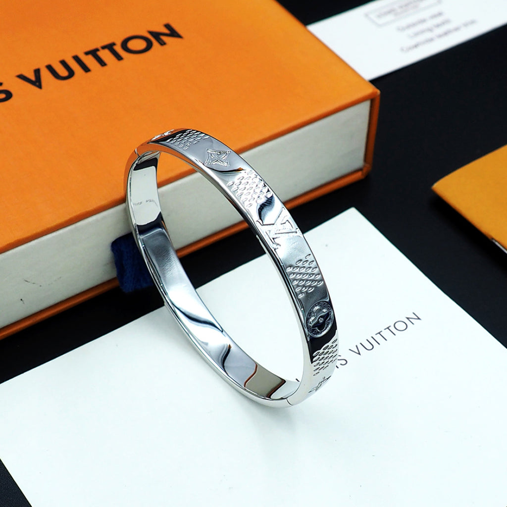 Louis Vuitton silver tone cuff bangle with engraved pattern