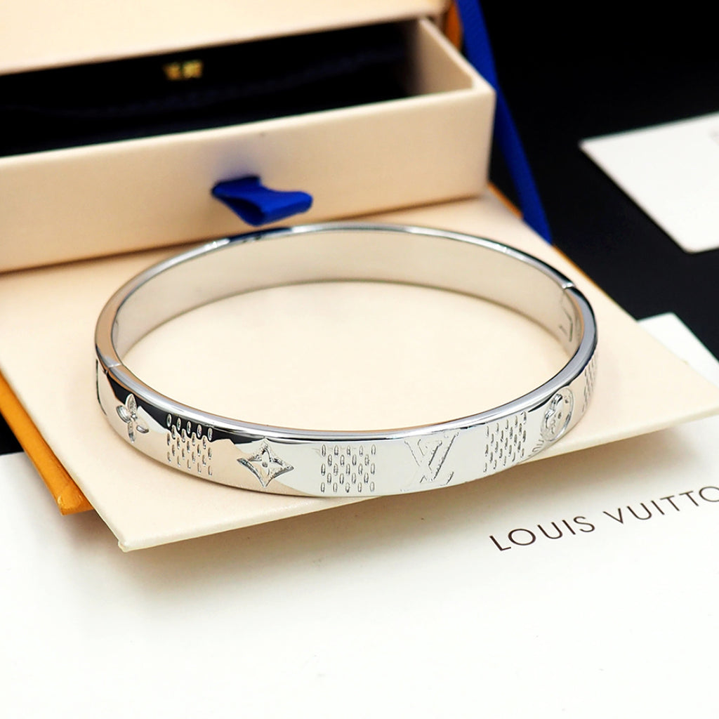 Louis Vuitton engraved silver cuff bracelet, smooth round profile with monogram pattern