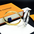 Louis Vuitton gold tone bangle bracelet with engraved texture