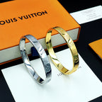Louis Vuitton metal bangles set in silver and gold with engraved pattern finish
